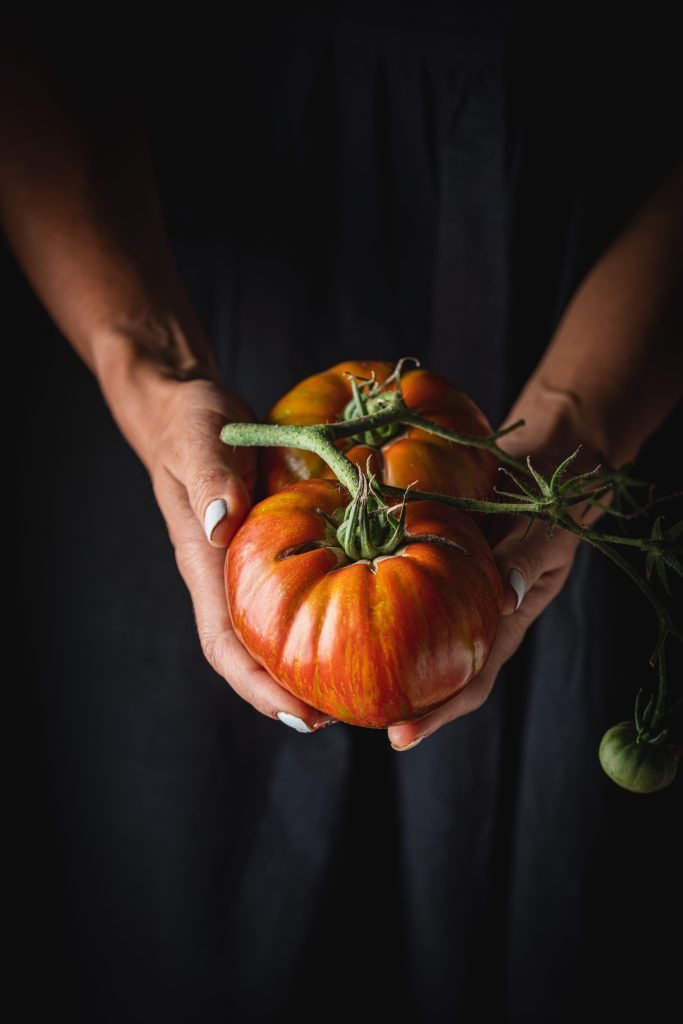 Red tomatoes in hands