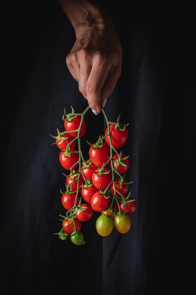 Red tomatoes in hands